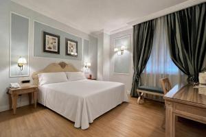 a bedroom with a large white bed and a window at Palazzo Alabardieri in Naples +58 photos