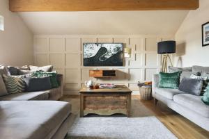 a living room with two couches and a coffee table at 1 Force Mill Barn - Ridgestone in Ulverston