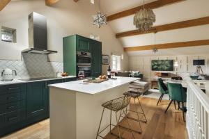 a kitchen with green cabinets and a white counter top at 1 Force Mill Barn - Ridgestone in Ulverston