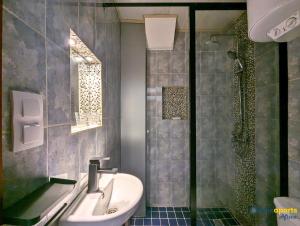 a bathroom with a sink and a shower at Chic studio with amazing view in Yaoundé +4 photos