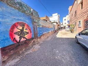a wall with a painting of a woman on it at Tamraght Waves Retreat 2 in Tamraght Ouzdar
