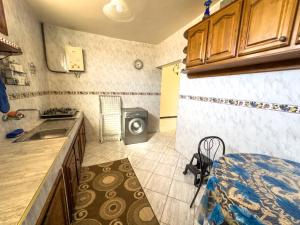 a small kitchen with a sink and a microwave at Tamraght Waves Retreat 2 in Tamraght Ouzdar