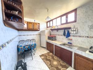 a kitchen with a table and a refrigerator at Tamraght Waves Retreat 2 in Tamraght Ouzdar