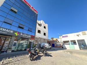 two motorcycles parked in front of a building at Tamraght Waves Retreat 2 in Tamraght Ouzdar +3 photos