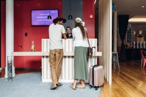 a man and a woman standing at a counter at Stay Hotel Lisboa Centro Chiado in Lisbon
