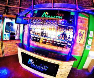 a bar with a barortment of bottles of alcohol at Amazon City in Pucallpa