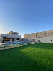a building with a green lawn in front of it at شاليه الدرة Durra Chalet in Amman
