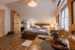 a bedroom with a large bed and a table at Rooms Murka in Bled