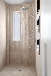 a shower with a shower curtain in a bathroom at Modern old town apartment in Bratislava +7 photos