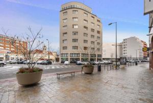 a building on a city street with a bench at Modern old town apartment in Bratislava