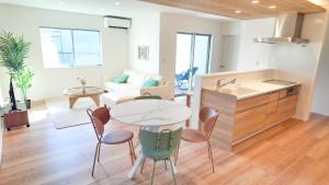a kitchen and living room with a table and chairs at 9Stay伊勢崎 in Isesaki