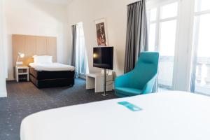a hotel room with a bed and a chair at Stay Hotel Lisboa Centro Chiado in Lisbon +93 photos