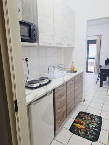 a kitchen with a sink and a counter top at Lovely Paceville Studio E in St. Julianʼs