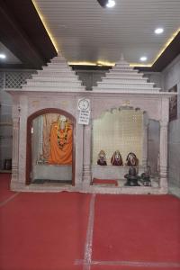 an image of a temple with an orange monk in it at Omji Ashram Jageshwar Mahadev in Varanasi