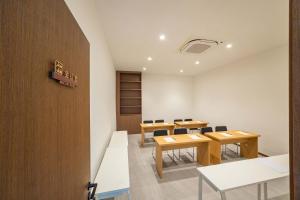 a meeting room with tables and chairs in a building at Shiershan · Yuntang Hotel in Qingdao