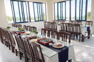 a dining room with tables and chairs with food on them at Daisy Hotel Tam Dao in Tam Ðảo