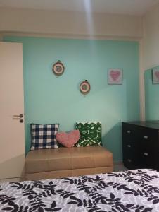 a bedroom with a bed and a blue wall at Nice relaxing apartment in Mandria, in Mandria +41 photos