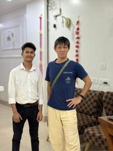 two men standing next to each other in a room at Hotel Samrat Residency Luxury At Nizamuddin Railway Station in New Delhi