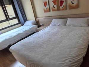 a bedroom with two beds and a window at Hostal San Isidro in Autol