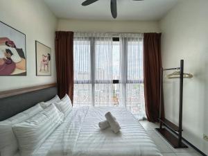 a bedroom with a bed and a large window at Le Cozy Cabin - 2B2R SeaCity View Infinity Pool in George Town +35 photos