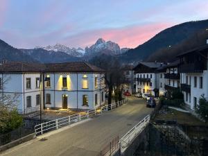 a street in a town with mountains in the background at Stella Alpina in Paularo