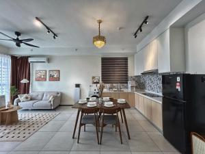 a kitchen and living room with a table and a black refrigerator at Le Cozy Cabin - 2B2R SeaCity View Infinity Pool in George Town