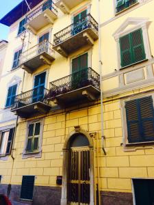 un edificio amarillo con balcones y una puerta en Casa Margot, en La Spezia