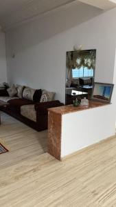 a living room with a couch and a mirror at Big Villa In Rabat in Rabat