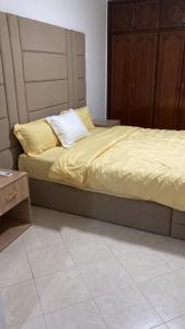 a bed with yellow sheets on it in a bedroom at Big Villa In Rabat in Rabat +23 photos