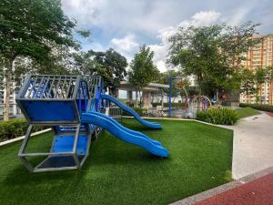 a playground with a blue slide in a park at Le Cozy Cabin - 2B2R SeaCity View Infinity Pool in George Town