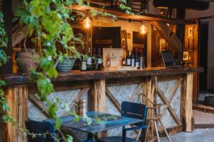 a wooden bar with a table and chairs at Rooms Murka in Bled