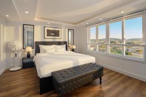 a bedroom with a large bed with a large window at 2Bi s Home Dalat 3 in Da Lat