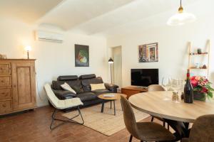 a living room with a couch and a table at Tenuta Dei Vicini - Luxury Apartments in San Marzano Oliveto