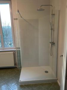 a bathroom with a shower with a glass door at LA Combe in Confolens