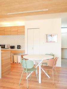 a kitchen and dining room with a table and chairs at 9Stay伊勢崎 in Isesaki +74 photos