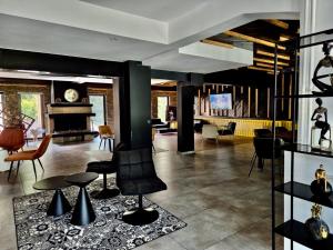 a living room with chairs and a fireplace at LAKEVIEW Hotel & Apartments in Mavrovo