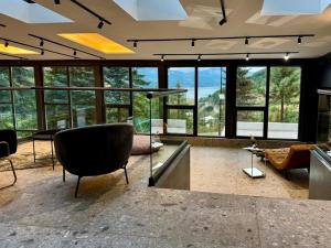 a large living room with a lot of windows at LAKEVIEW Hotel & Apartments in Mavrovo