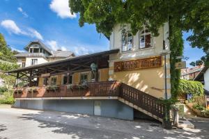 a building with a balcony on the side of it at Rooms Murka in Bled