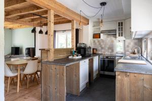 a kitchen with wooden cabinets and a table in it at 't Jongehof in Zaffelare
