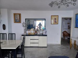 a kitchen with a table and a dining room at Appartement vue mer in Saint-Raphaël
