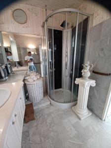 a man taking a picture of a shower in a bathroom at Appartement vue mer in Saint-Raphaël +15 photos