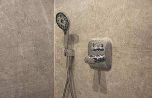 a shower with a blow dryer in a shower stall at Ferienwohnung Petra in Ilmenau +30 photos