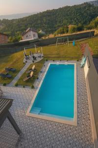a large swimming pool on top of a house at Villa Kaplan Sarajevo in Gladno Polje +41 photos