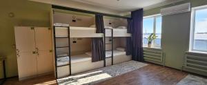 a room with four bunk beds and a window at Koktem hostel in Aktobe