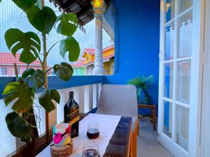 a table with a bottle of wine and a plant at Villa Marina -By The Beach Goa in Benaulim