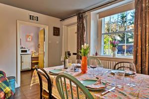 a dining room with a table and chairs and a window at Finest Retreats - Flittermouse Cottage in Wingfield +15 photos