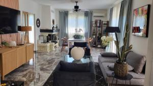 a living room with a couch and a table at Hôtel Boquier, Avignon Centre in Avignon