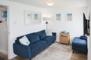 a living room with a blue couch and a blue chair at 1 Bed in St Ives oc-crab02 in St Ives