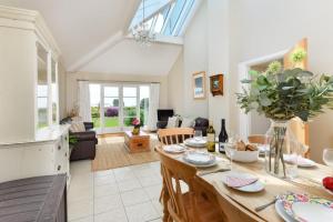 a kitchen and living room with a table and chairs at 5 Bed in Pwllheli oc-1coedy in Abersoch