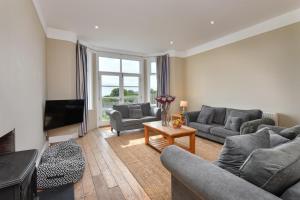 a living room with two couches and a television at 5 Bed in Pwllheli oc-1coedy in Abersoch
